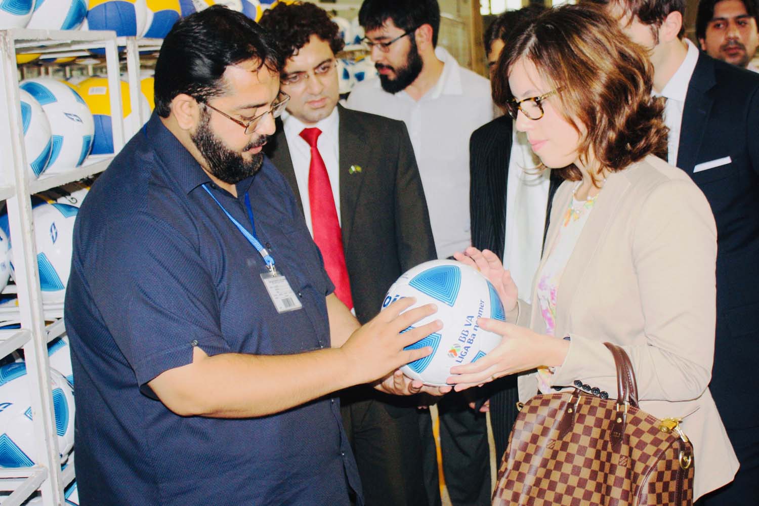 Our team member shows the unique panel cut football designed at Madrigal.